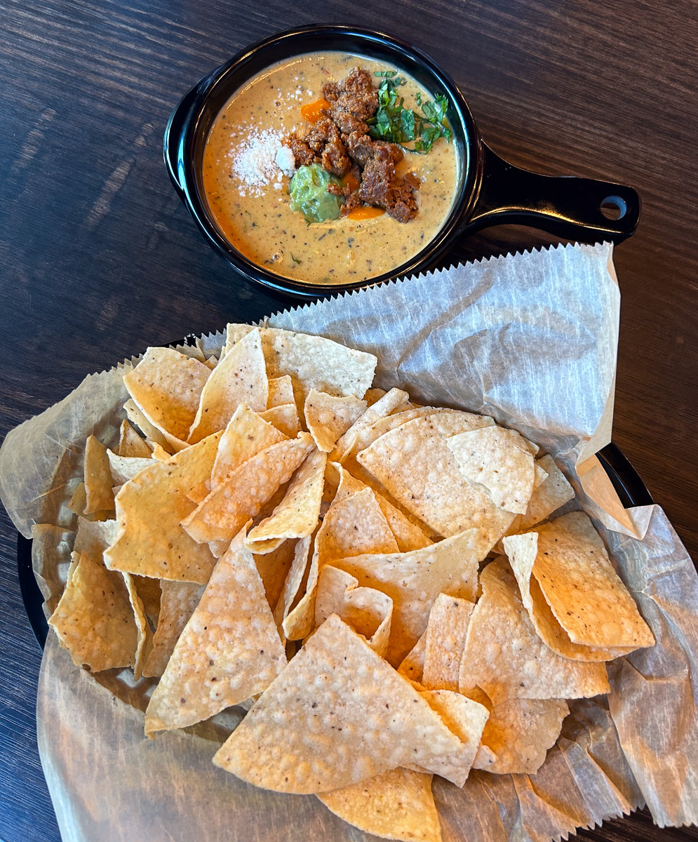 queso with meat and plate of chips